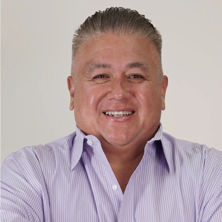 Mario Campirano in a lavender striped shirt