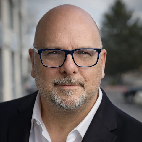Joe O’Grady wearing glasses and a dark jacket